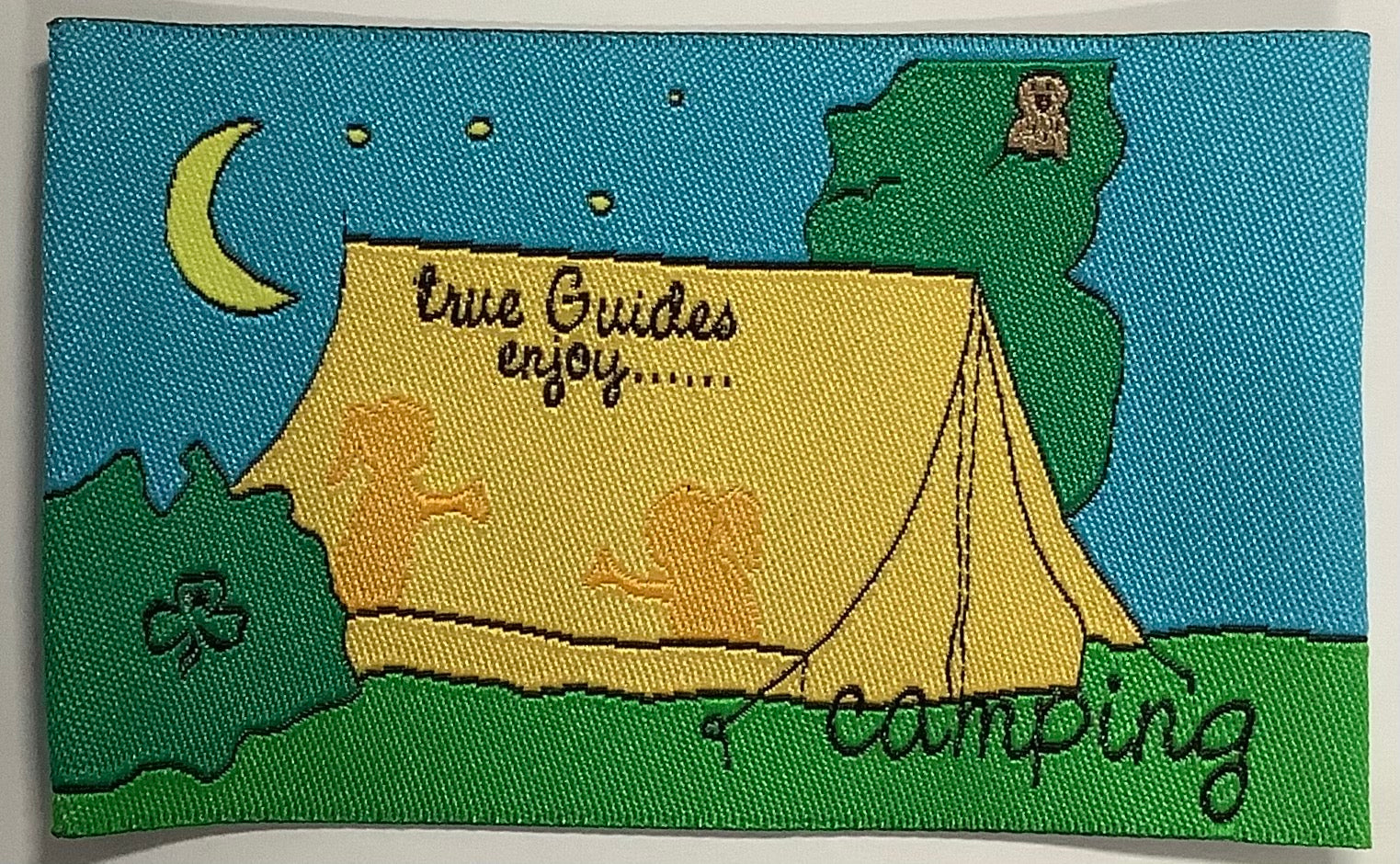 a square unbound badge with a yellow tent in an outdoor setting