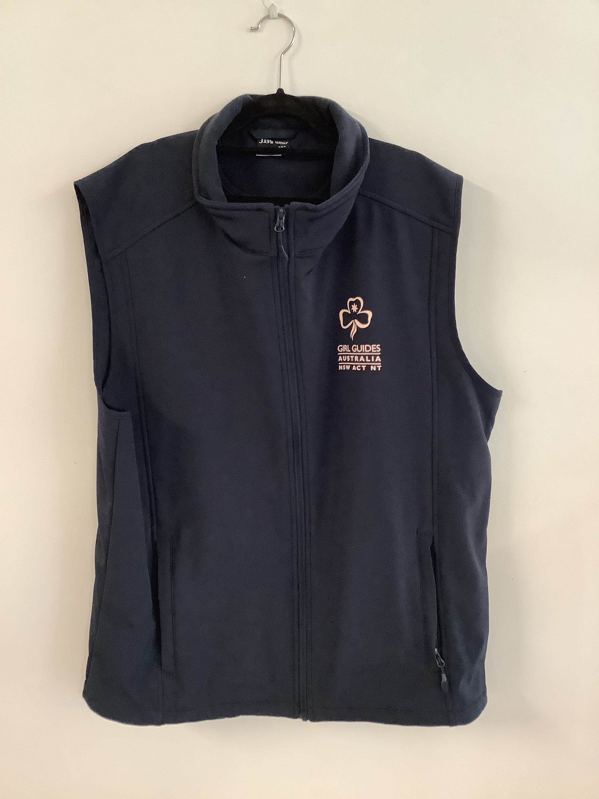 a navy blue vest with Girl Guides Australia NSW ACT NT