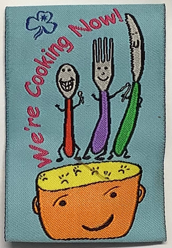 a rectangular unbound badge with a pot with a knife, fork and spoon
