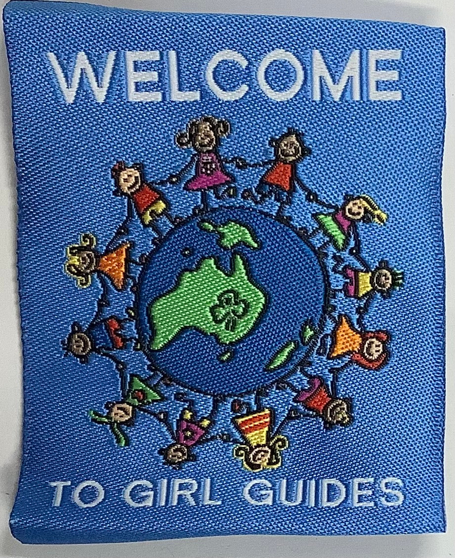 a square unbound badge with a globe with girls holding hands standing all around the globe
