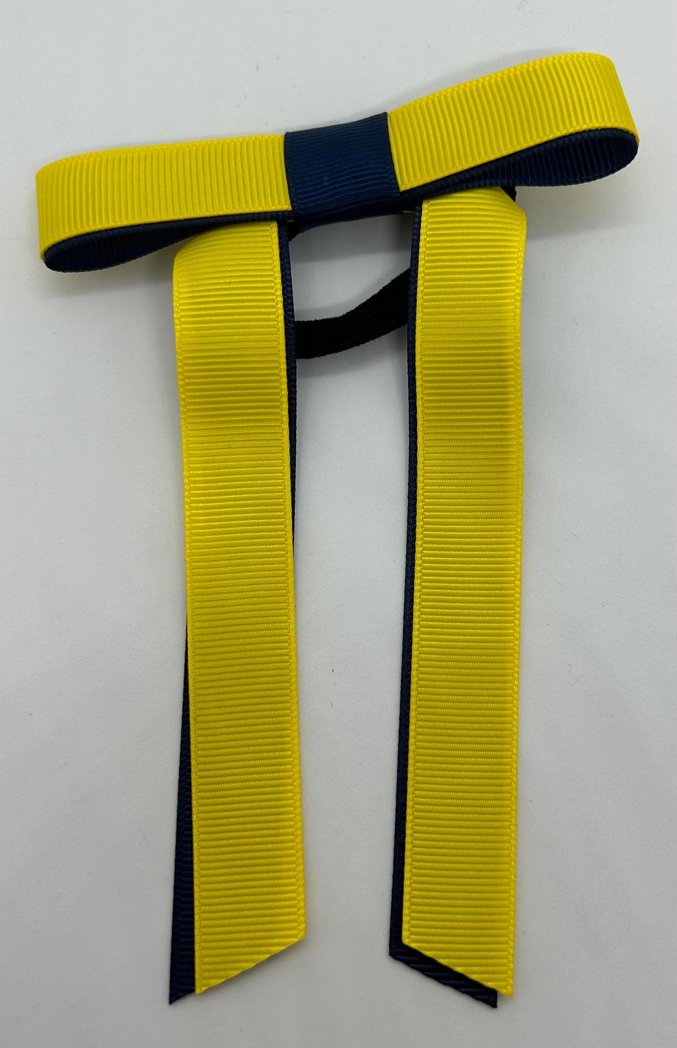 a yellow and navy hair bow with long tails