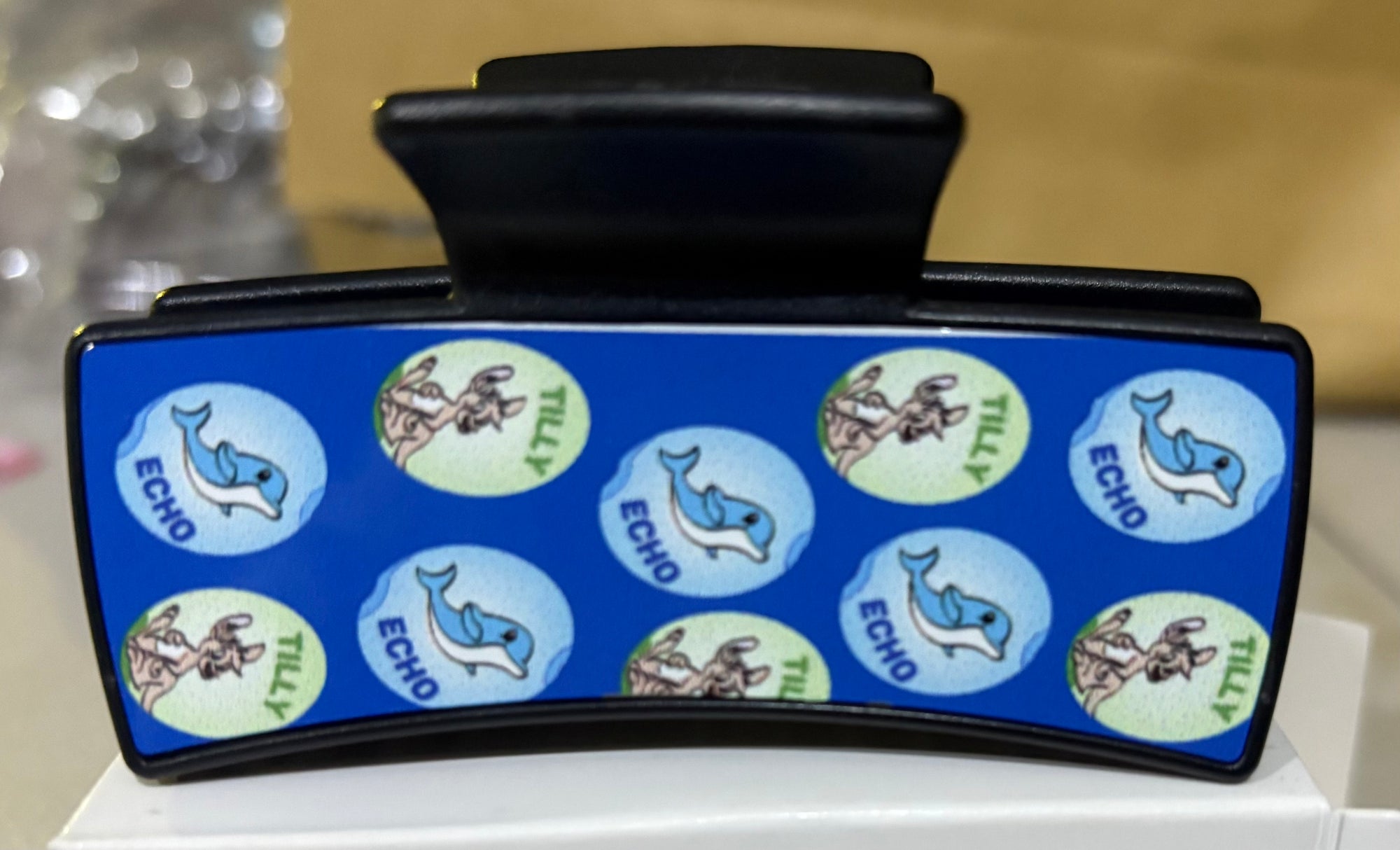 A black claw hair clip with images of Tilly and Echo