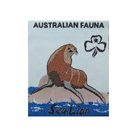 unbound badge with a brown sea lion sitting on a grey rock with the trefoil and writing in black on a background that is half royal blue and half light blue