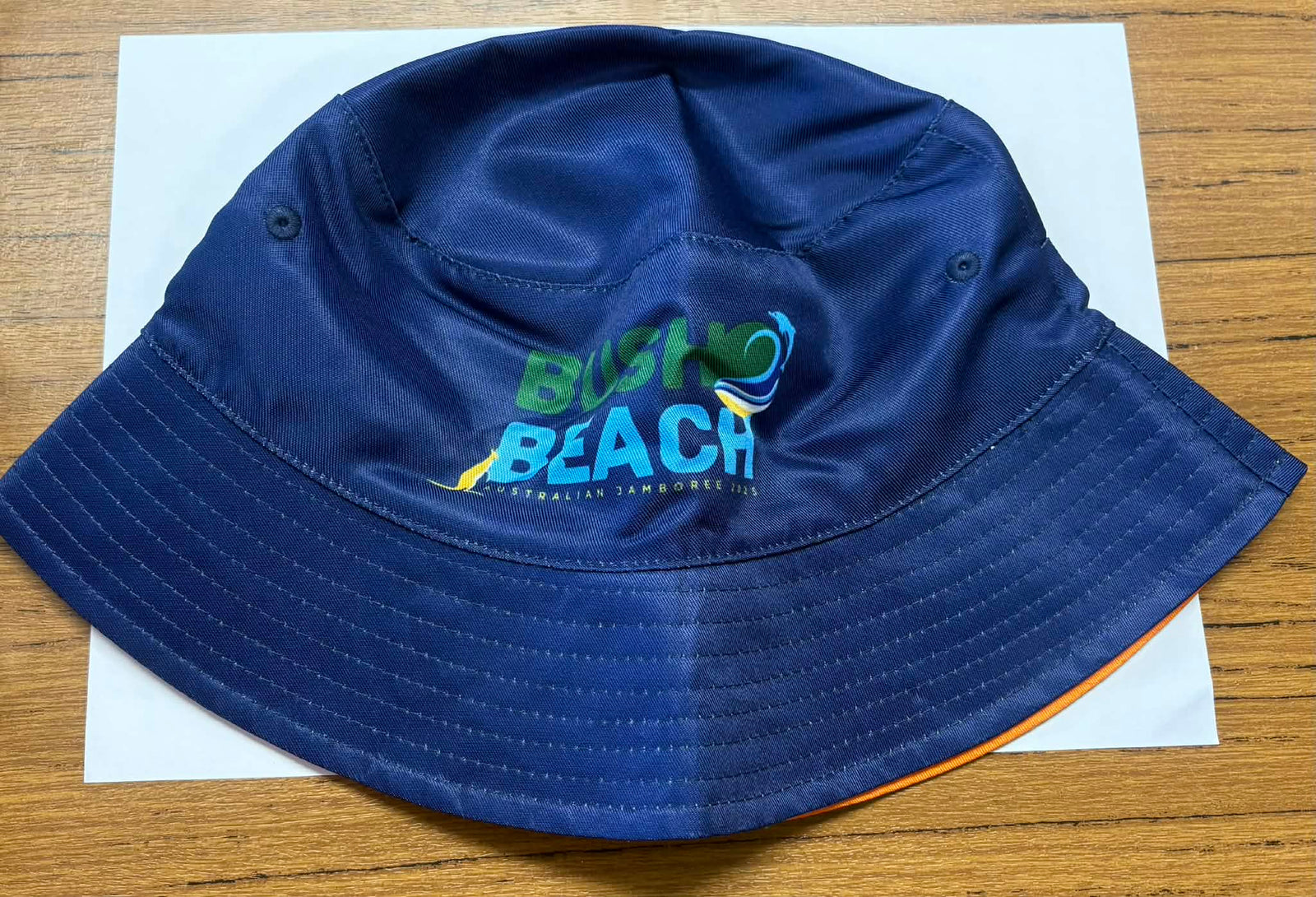 Blue bucket hat with 'Girl Guides Australia' logo and B2B branding on the blue side. On the range side there are pictures of the mascots Echo and Tilly