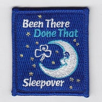 bound square badge that has a quarter moon embroidered in white and some stars in silver