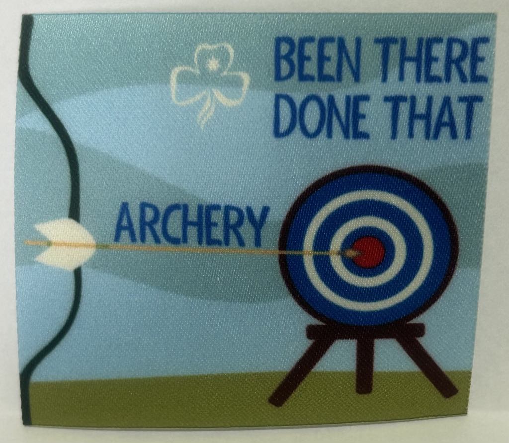 a square unbound badge with an archery target and arrow in the centre with the words been there done that archery in blue