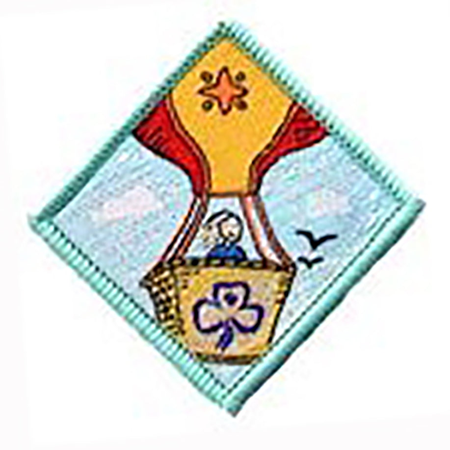 diamond shaped bound in light green badge with a girl in a hot air balloon