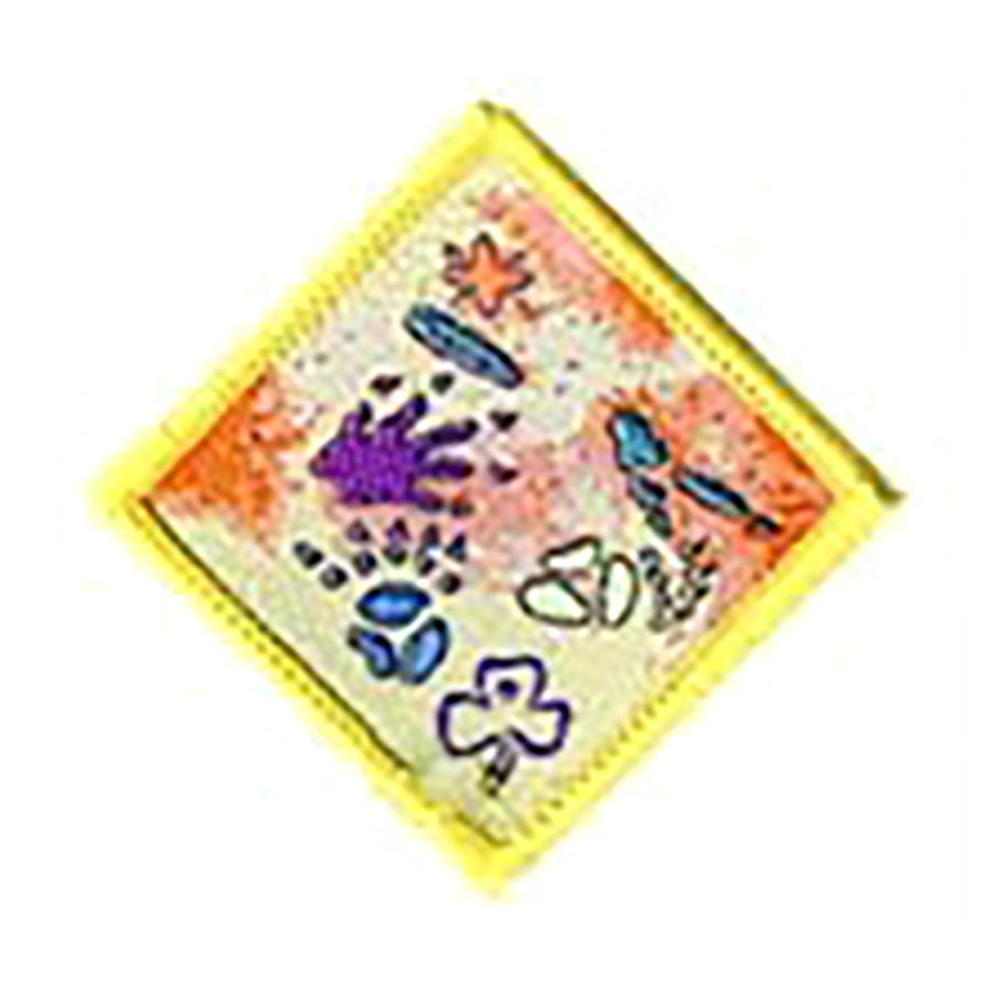 diamond shaped bound in yellow badge with different animal footprints