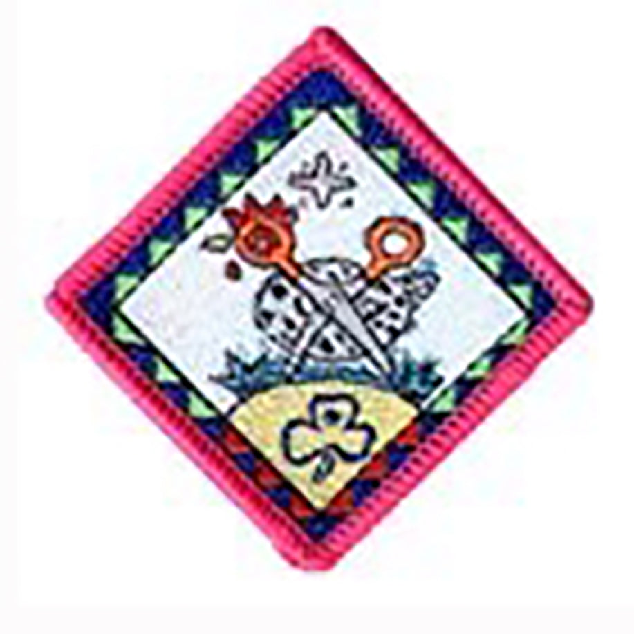 diamond shaped badge bound in oink with a pair of scissors imposed over a chicken picture with the blades of the scissors being the chickens legs