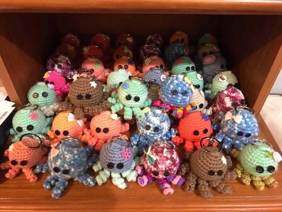 a small crochet octopus with a key chain on the top. These come in various colours with various embellishments and will be selected at random if ordered.