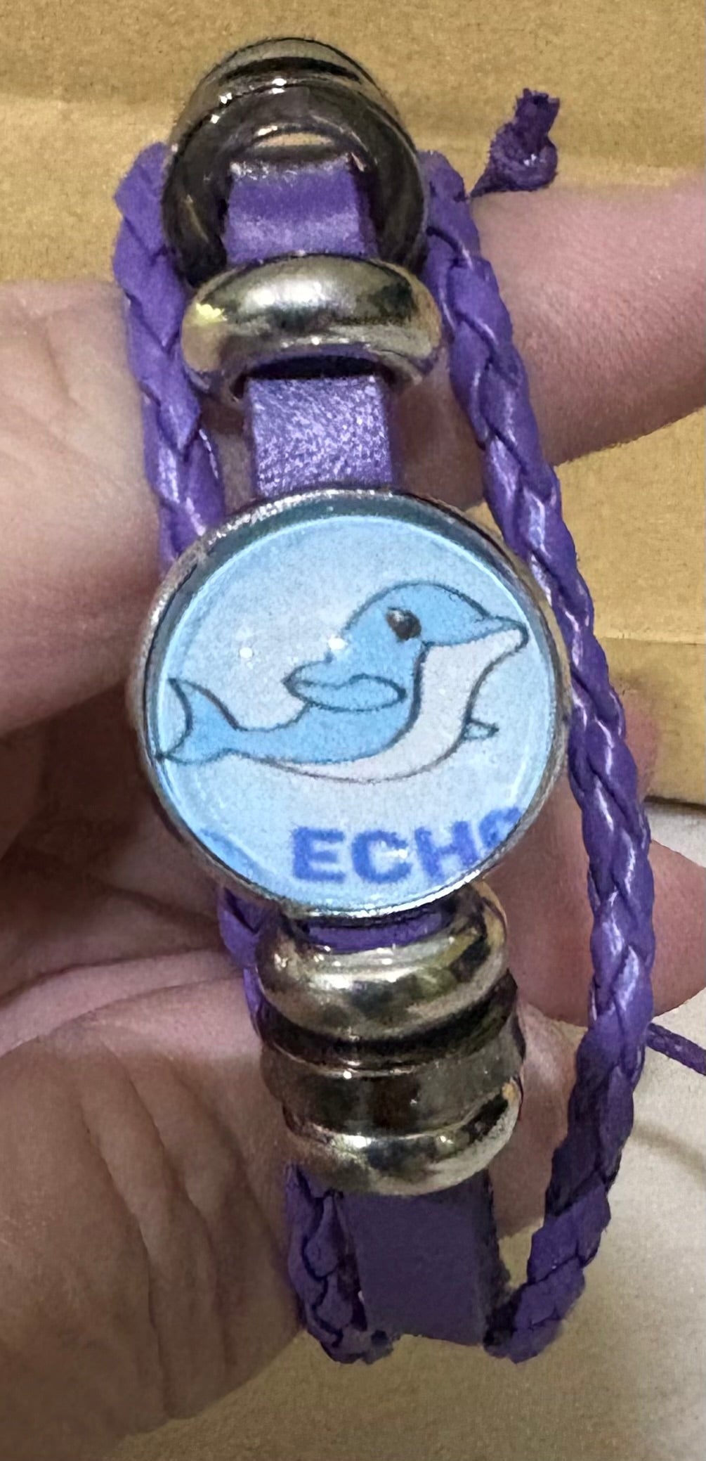 A faux leather bracelet with an image of Echo the jamboree dolphin 