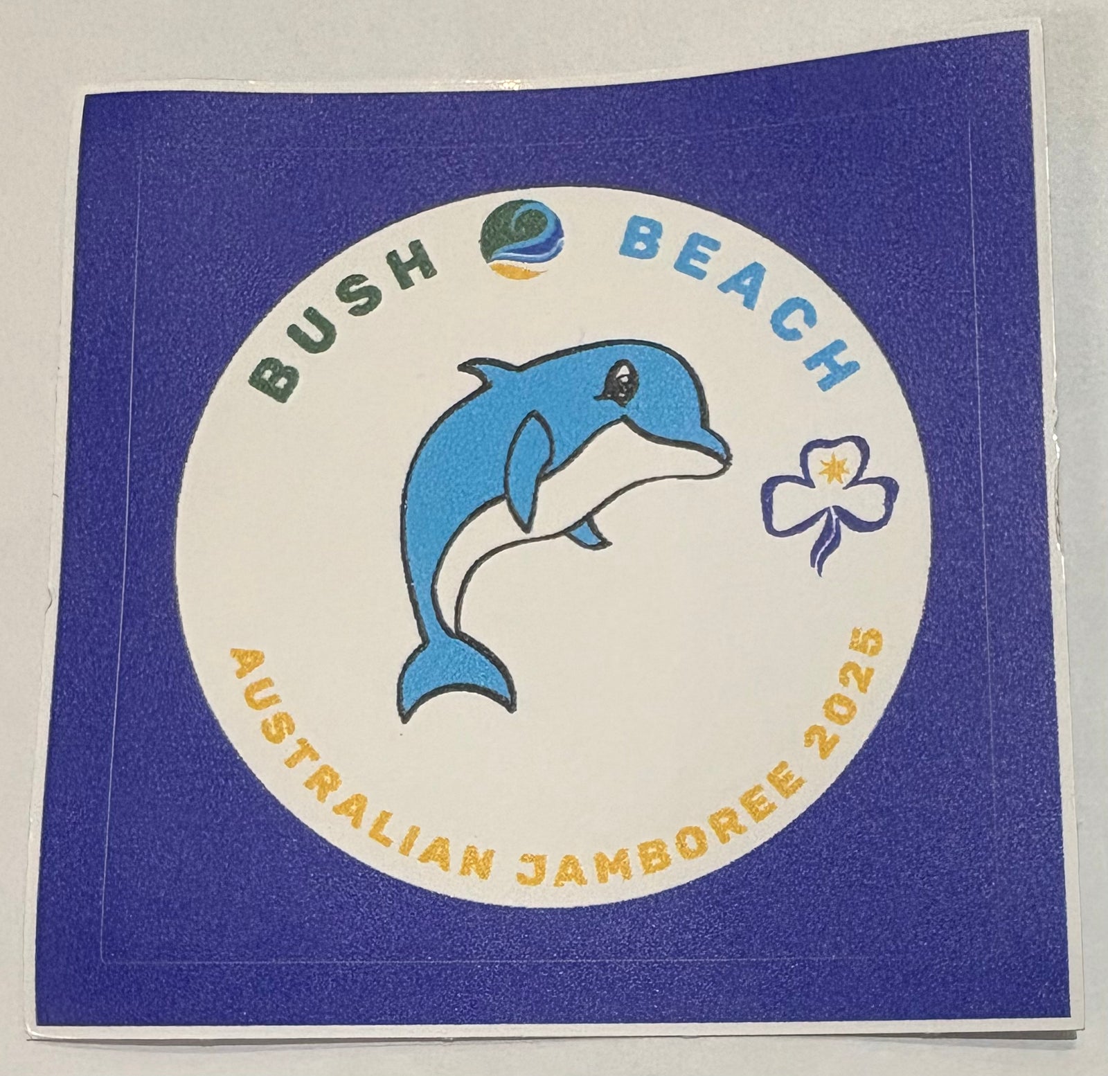 A round white sticker with Echo the dolphin 