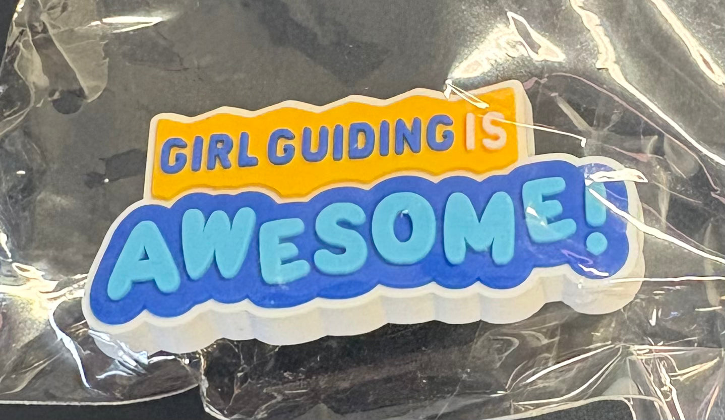 A croc charm that says girl guiding is awesome 