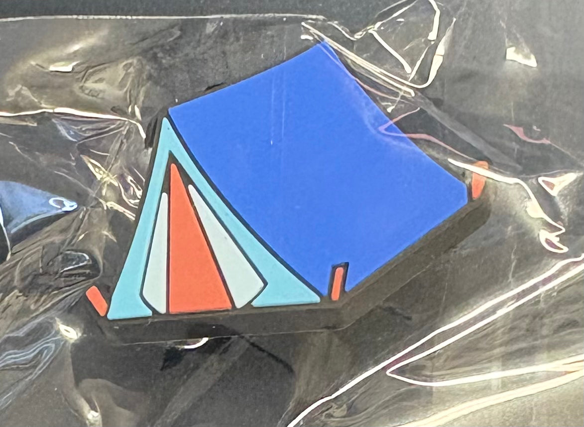 A croc charm that is a blue tent