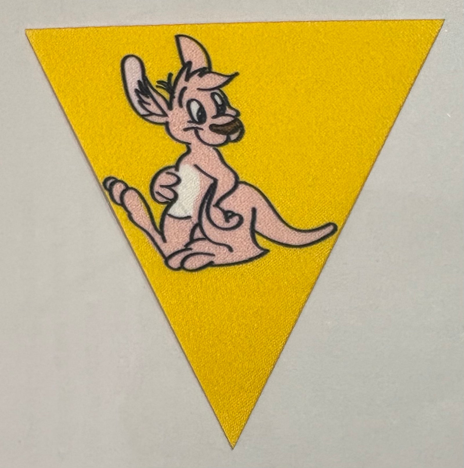 A yellow triangle badge with Tilly