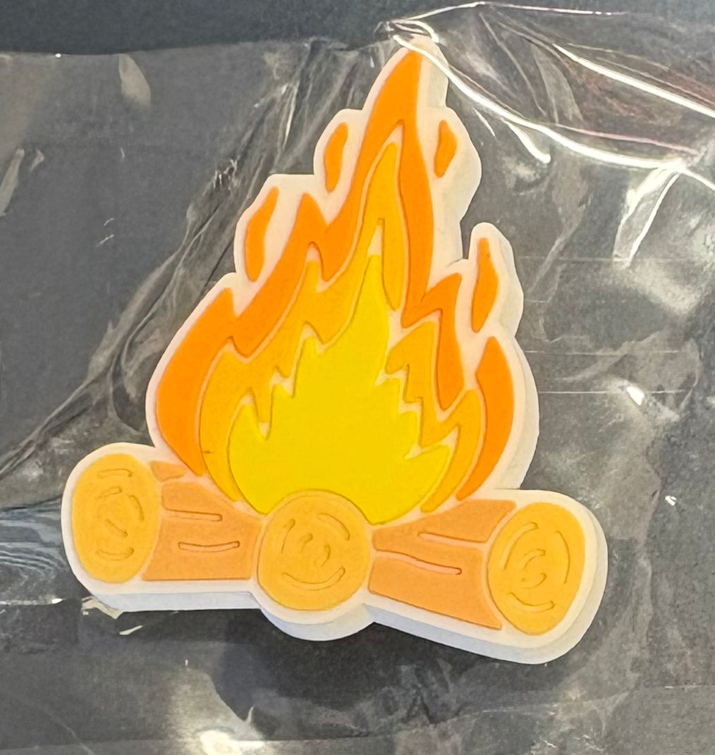 A croc charm that is a campfire 