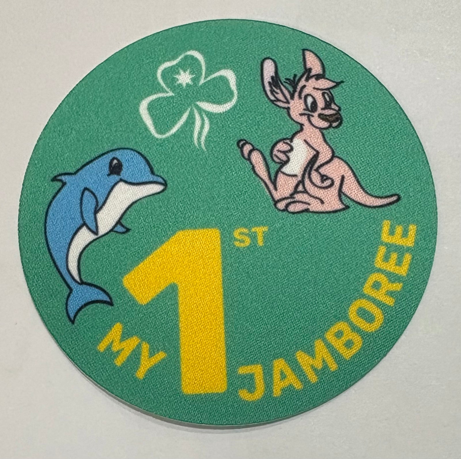 A round green unbound badge with a dolphin and a kangaroo 