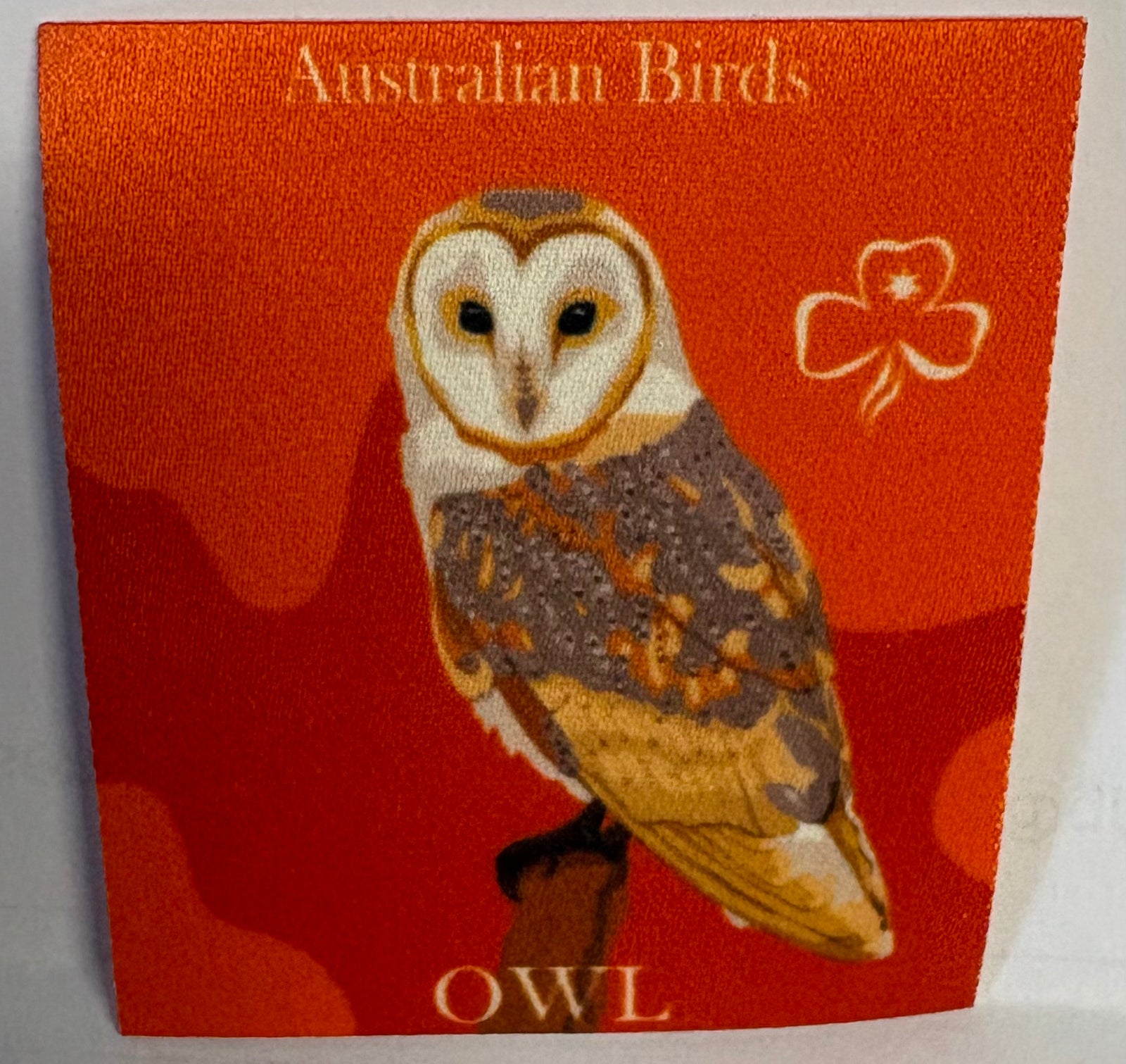 A square unbound badge with an illustration of an owl on an orange background, labeled 'Australian Birds Owl'.