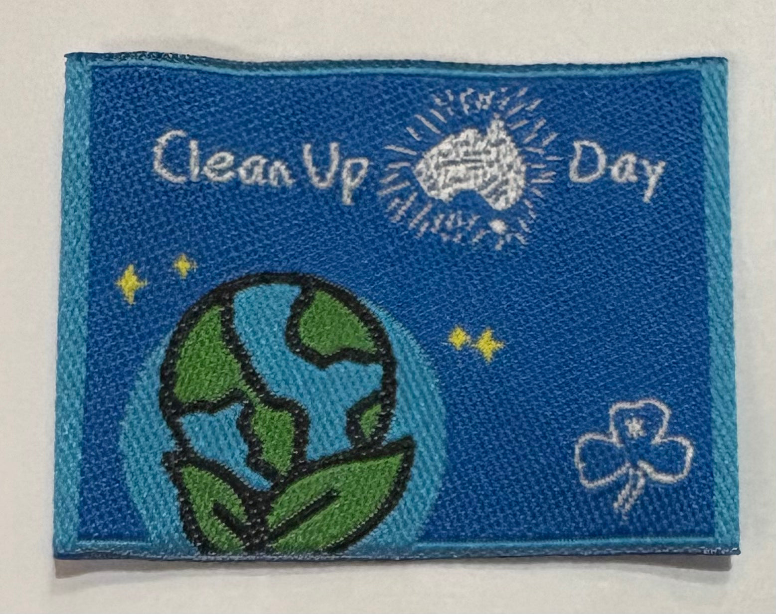 A blue unbound badge with clean up Australia Day and a globe with leaves 