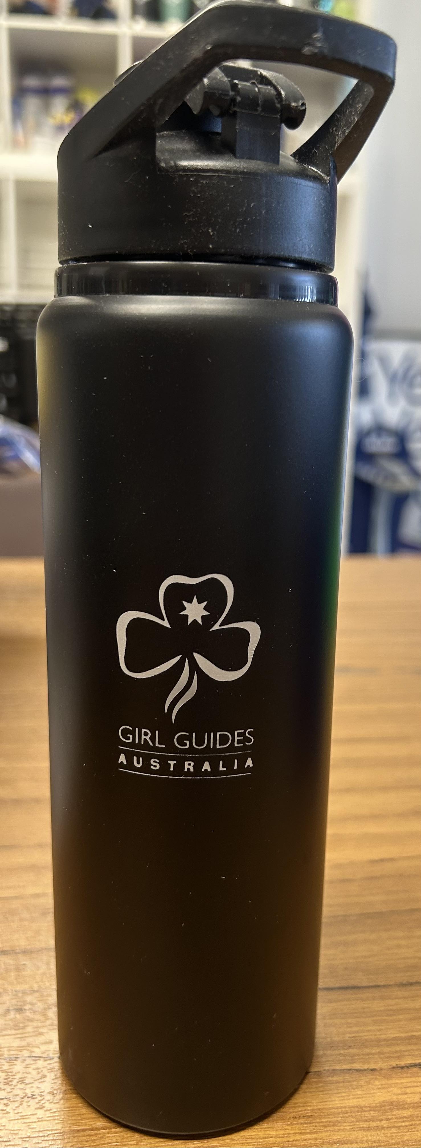 a black aluminium drink bottle with the trefoil and Girl Guides Australia engraved on it