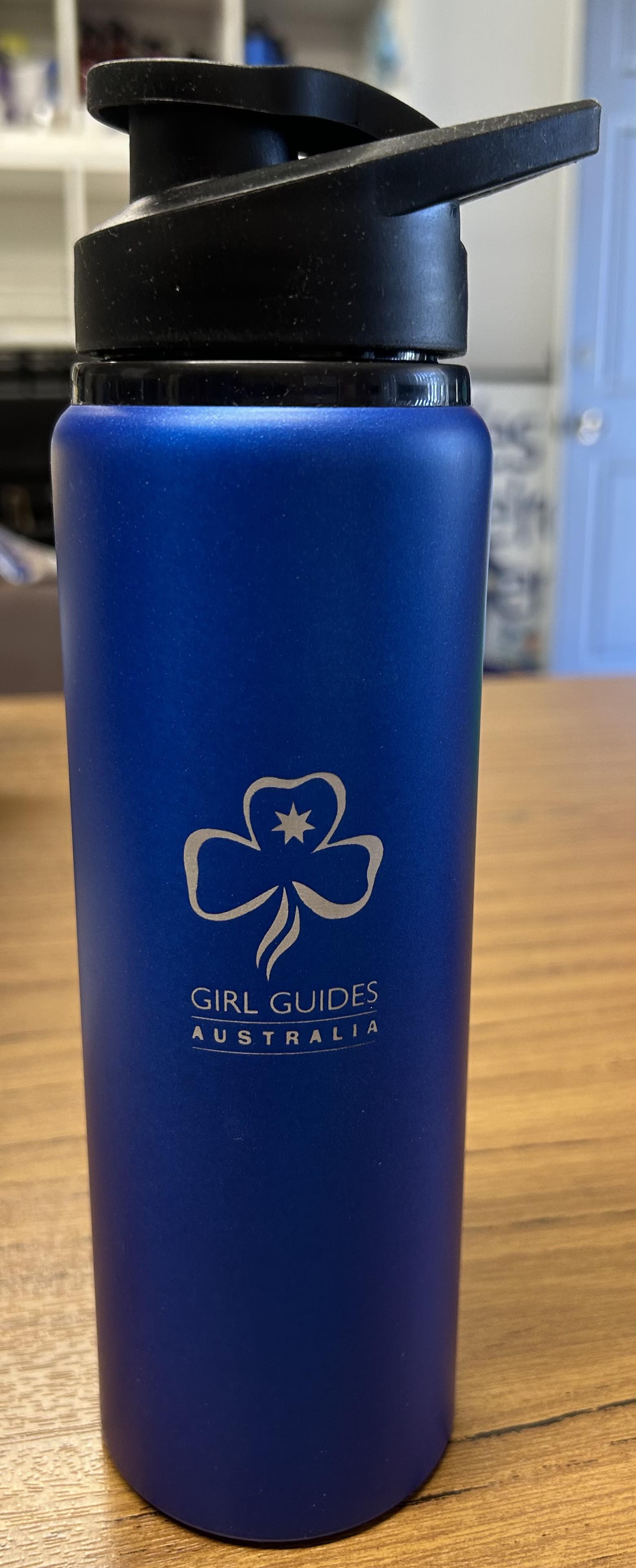 a blue 750ml aluminium drink bottle with the trefoil and Girl Guides Australia engraved on it