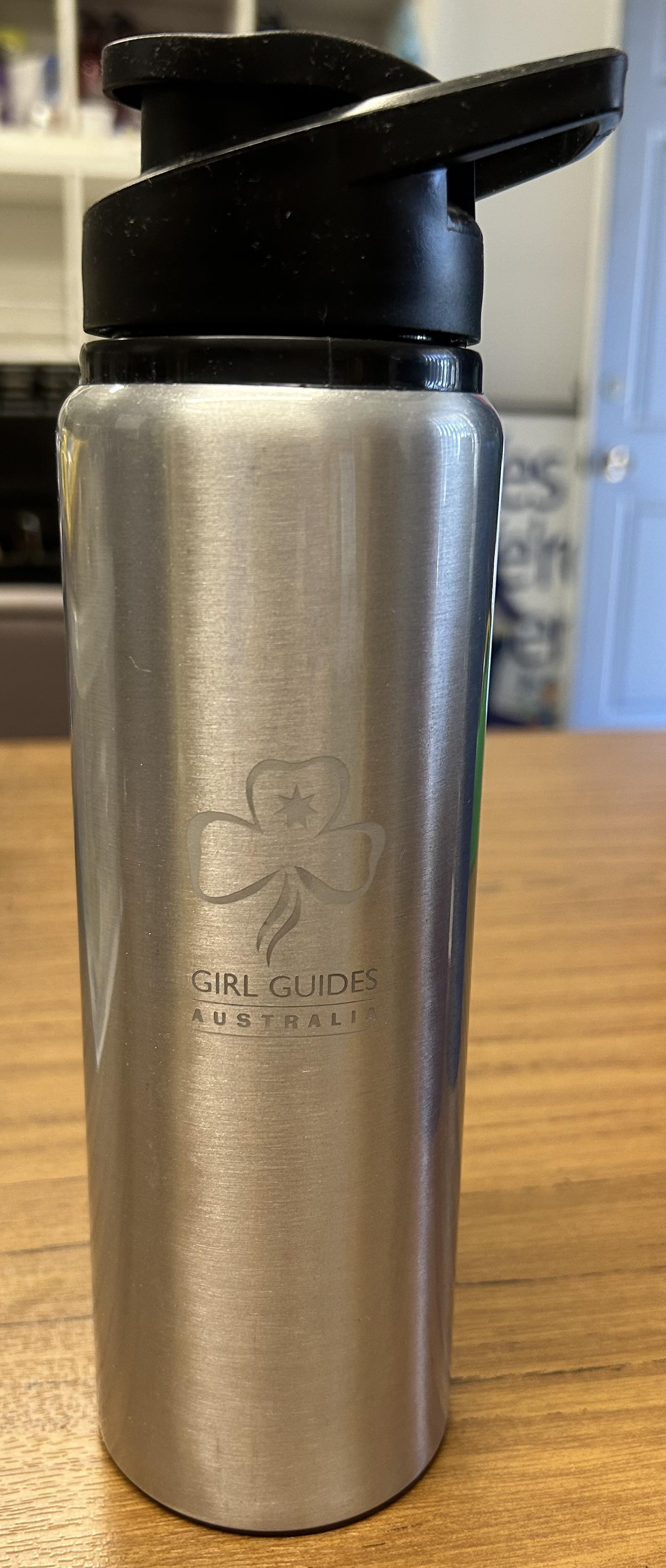 a silver 750ml aluminium drink bottle with the trefoil and Girl Guides Australia engraved on it