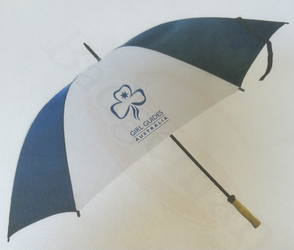a blue and white umbrella with a trefoil and girl guides Australia printed on it