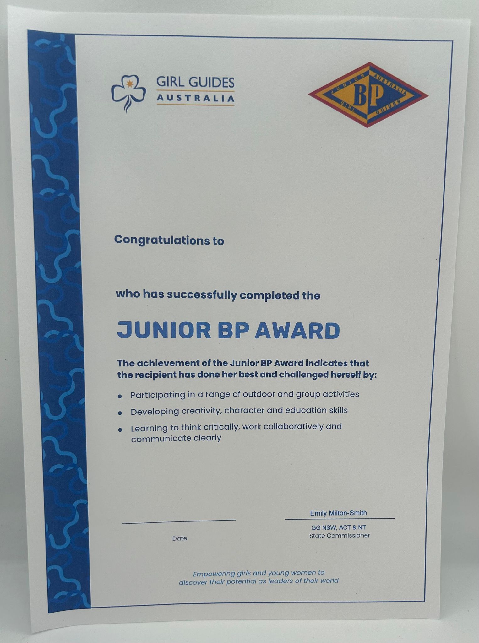 an A4 certificate from the state commissioner that is awarded to the girl who has achieved this award