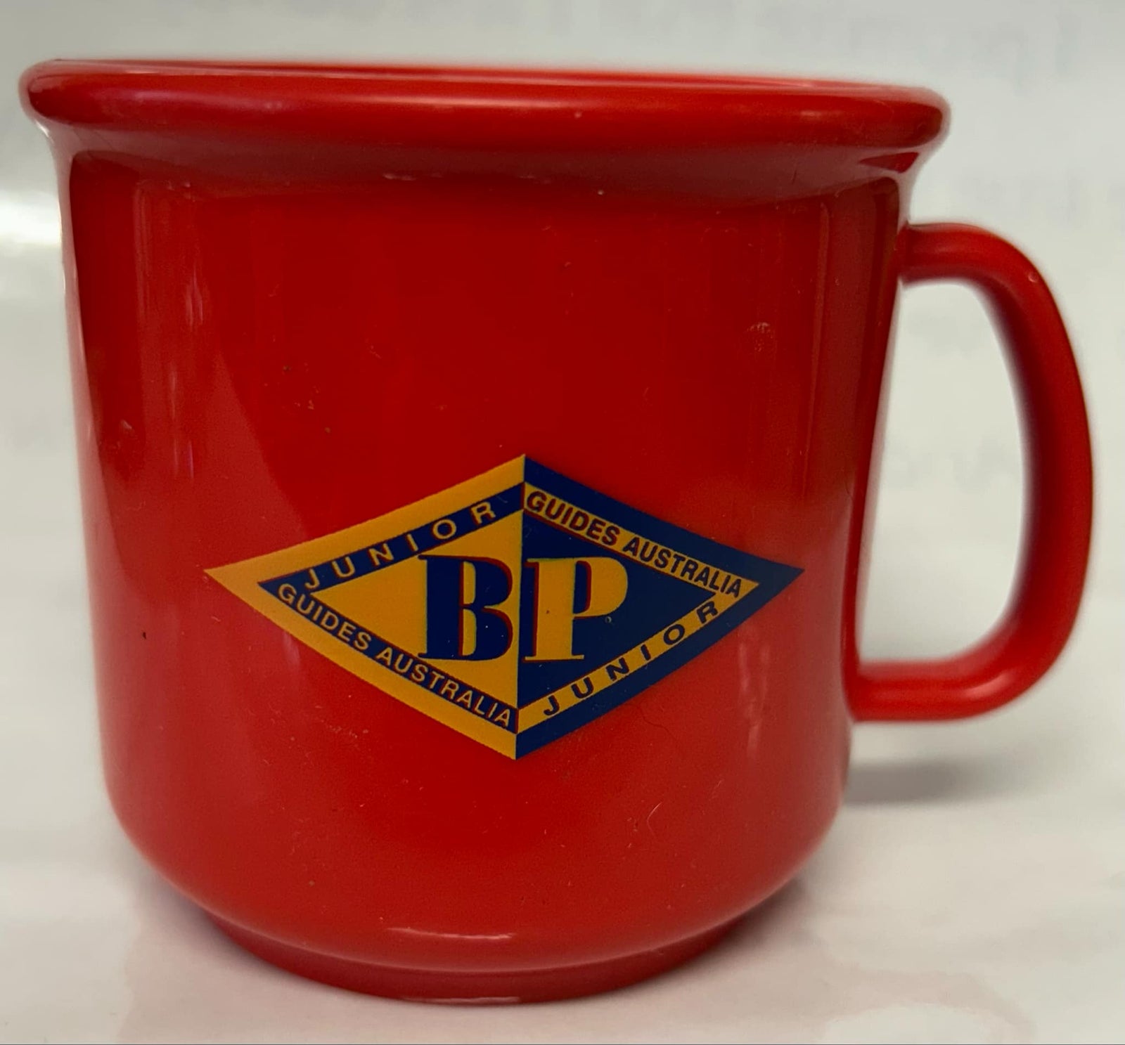 a red cup with the JBP emblem and guides Australia on the front