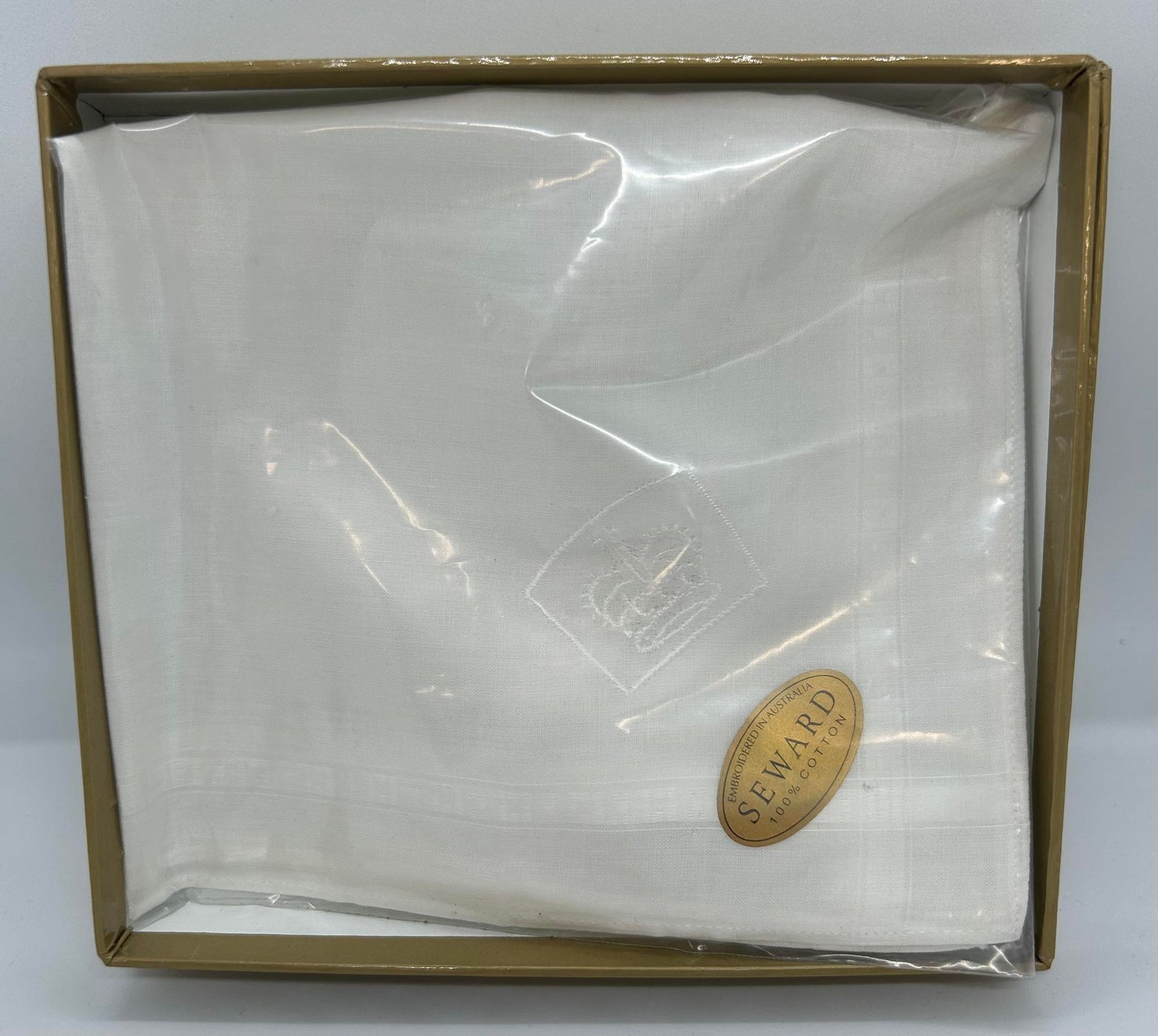 a white hankie with the queens guide emblem embroidered in one corner