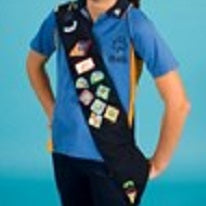 a blue sash that is worn to display badges that have been earned