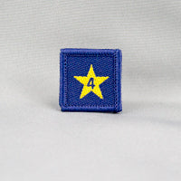 square blue badge with a gold star with the number four in the centre written in blue