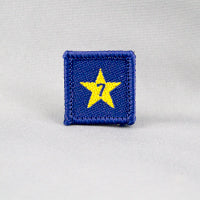 square blue badge with a gold star with the number seven in the centre written in blue
