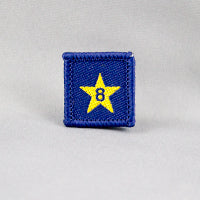 square blue badge with a gold star in the middle with the number eight in the centre written in blue
