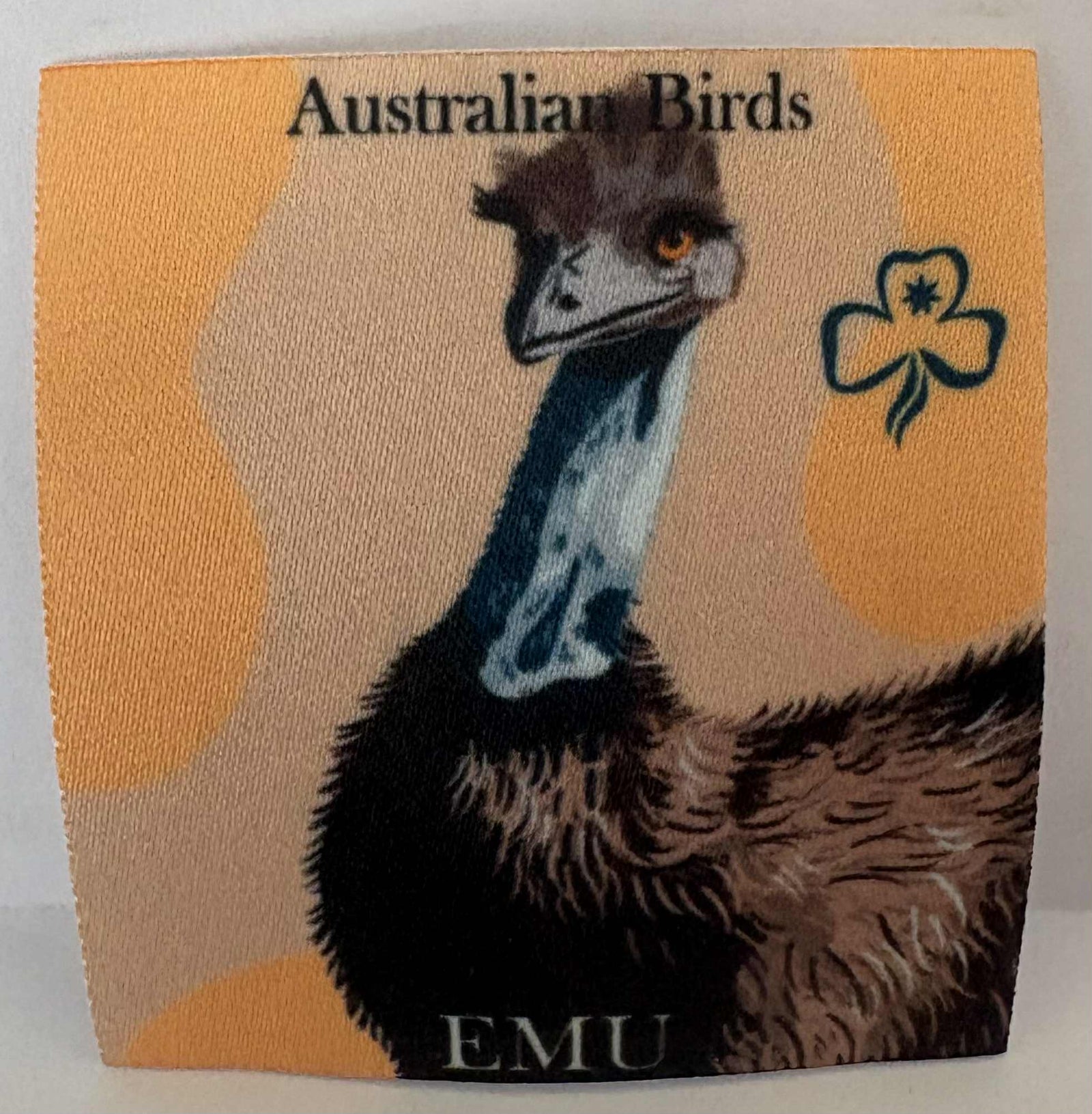 Emu illustration on a square unbound badge 'Australian Birds' with 'EMU' text.