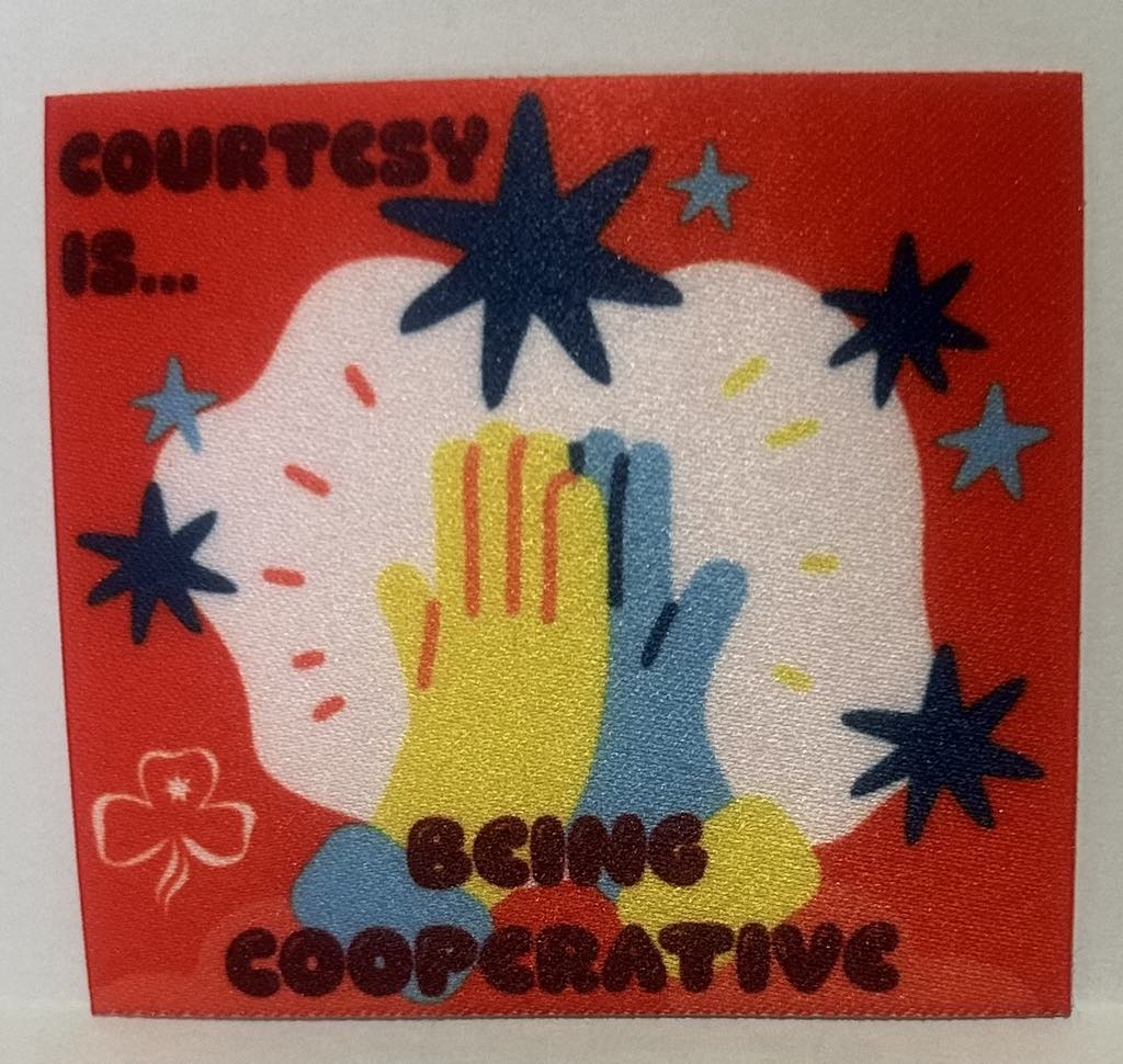 a square unbound badge with a red background with blue stars and two hands high fiving and the words courtesy is being cooperative
