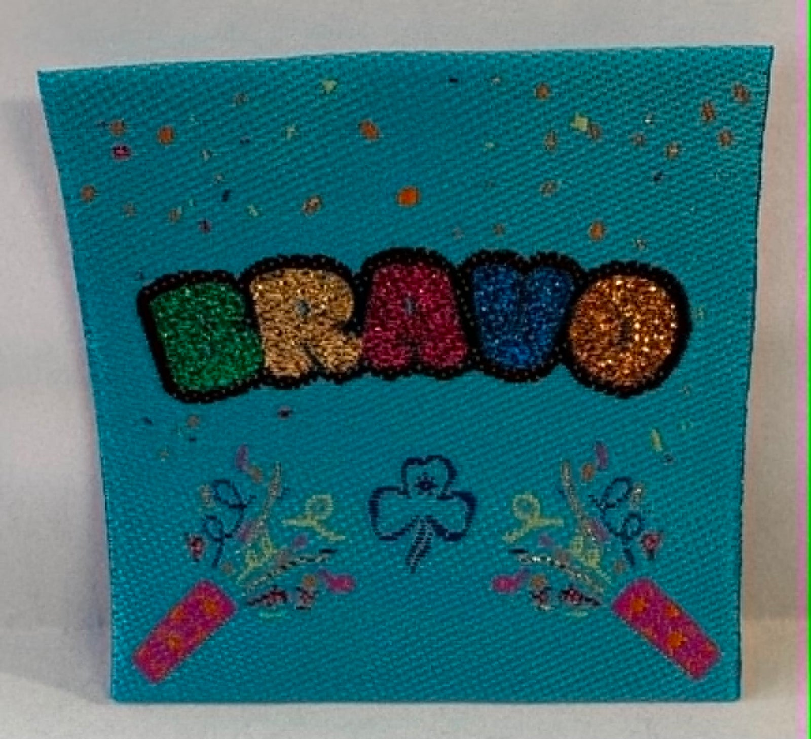 Square blue unbound badge with 'BRavo' in colourful letters on a blue background
