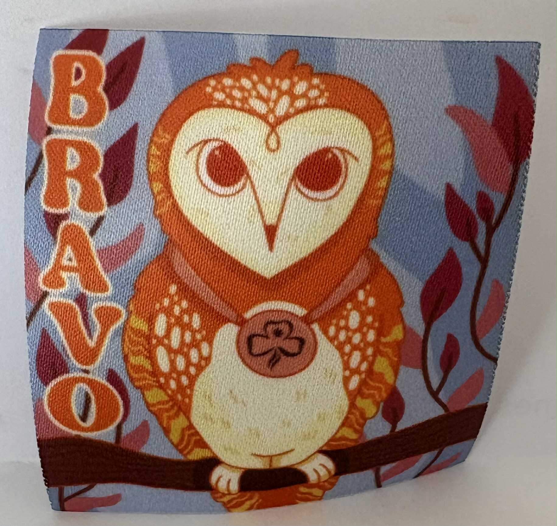 a square unbound badge with an owl design and 'BRAVO' text on a blue background