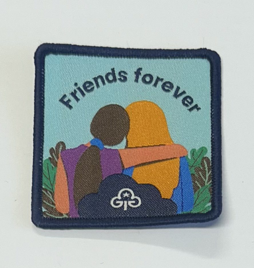 a square bound badge with the back of two girls on the badge with one girls arm wrapped over the shoulders of the other girl