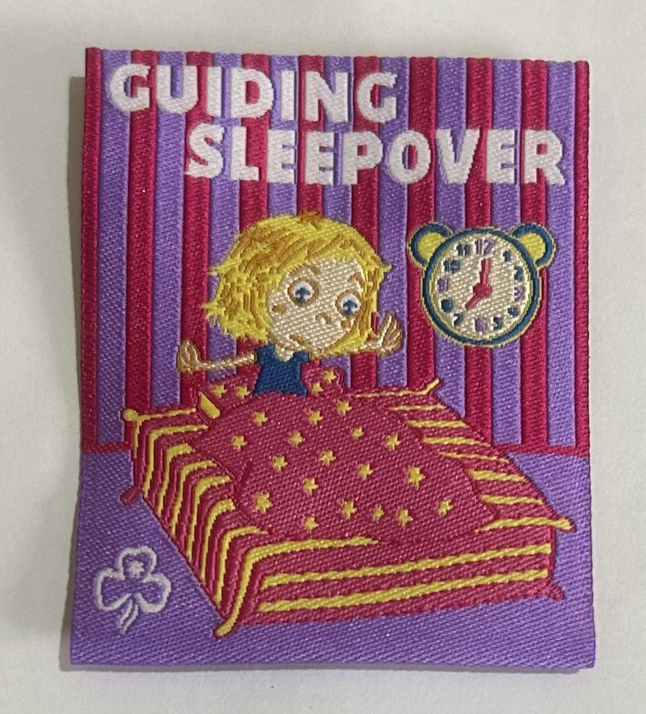a square unbound badge with a pink and purple background with a girl in a pink and yellow striped bed