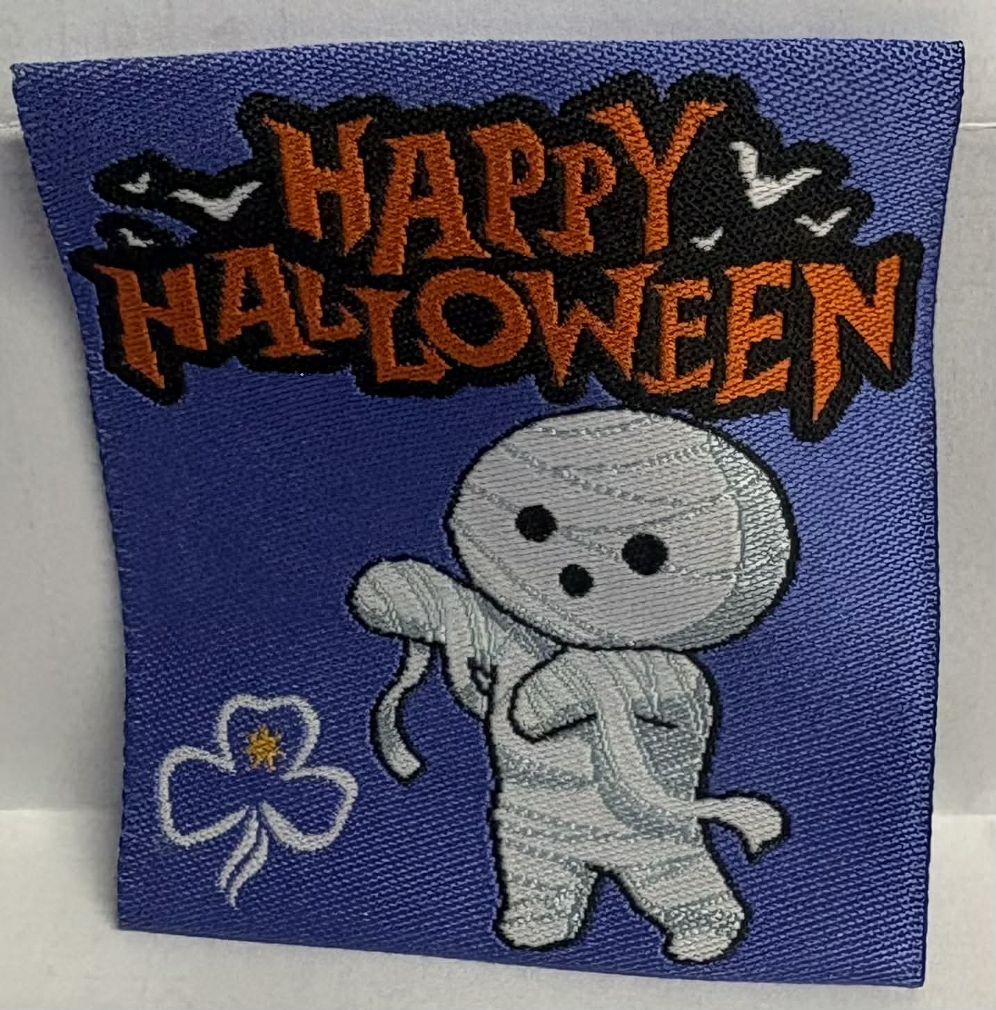 Embroidered patch with a mummy character and 'Happy Halloween' text on a purple background