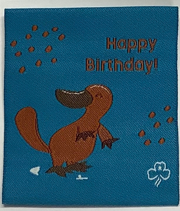 a square unbound badge that is blue with a brown platypus