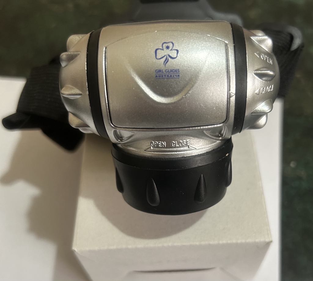 a silver head torch with a black band
