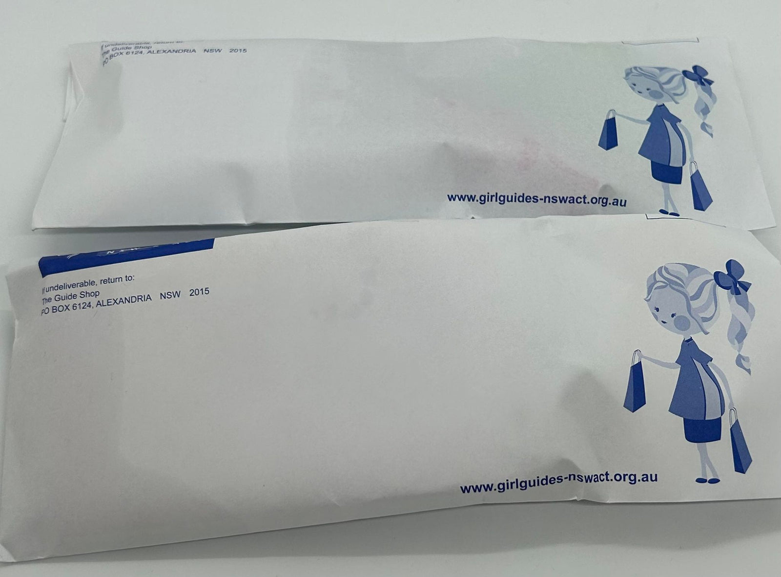 an envelope or bag with surprises and some badges