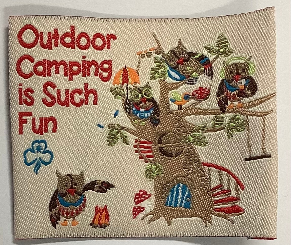 a square unbound badge that has owls playing in a tree