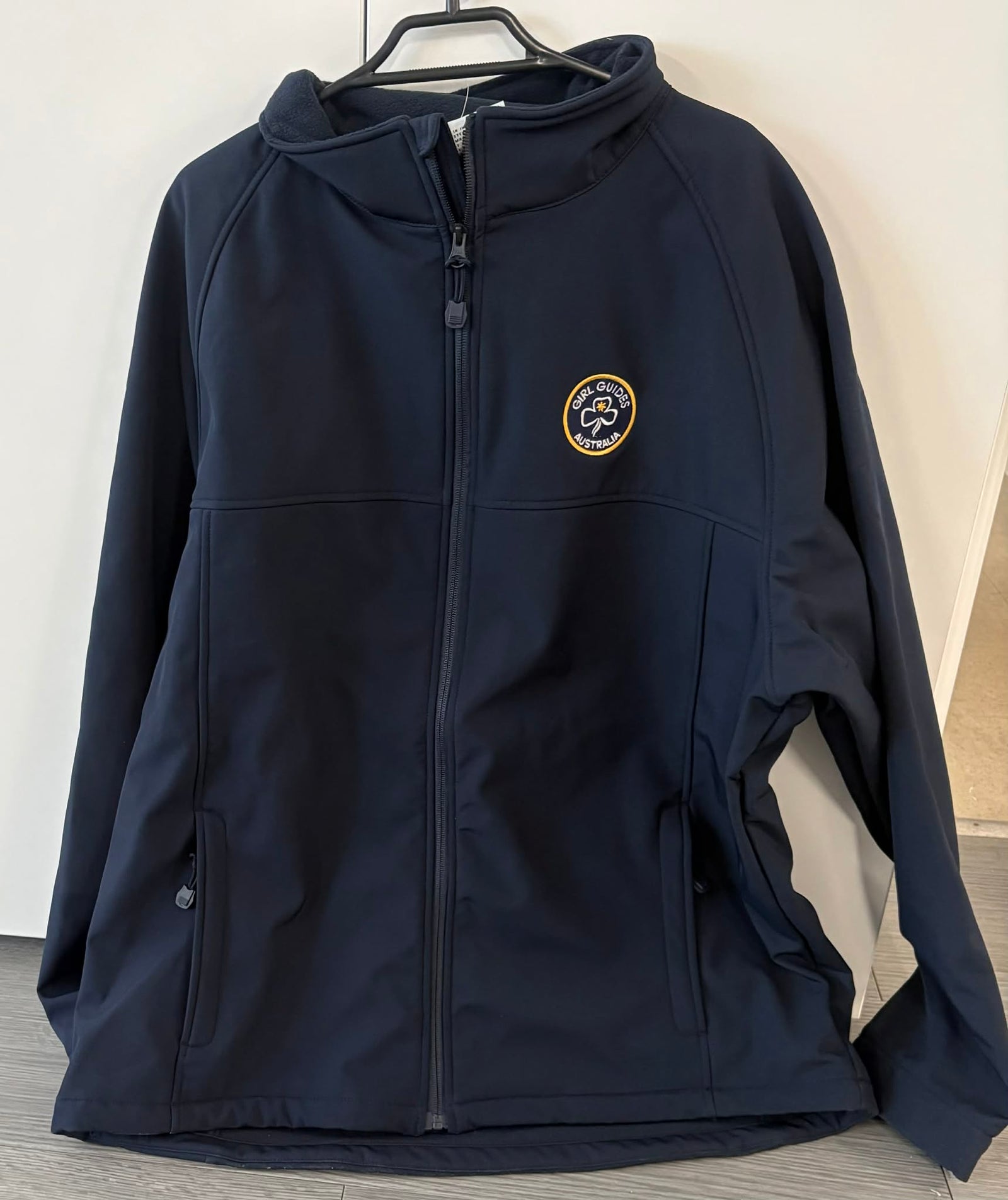 Navy blue jacket with a Girl Guides Australia logo