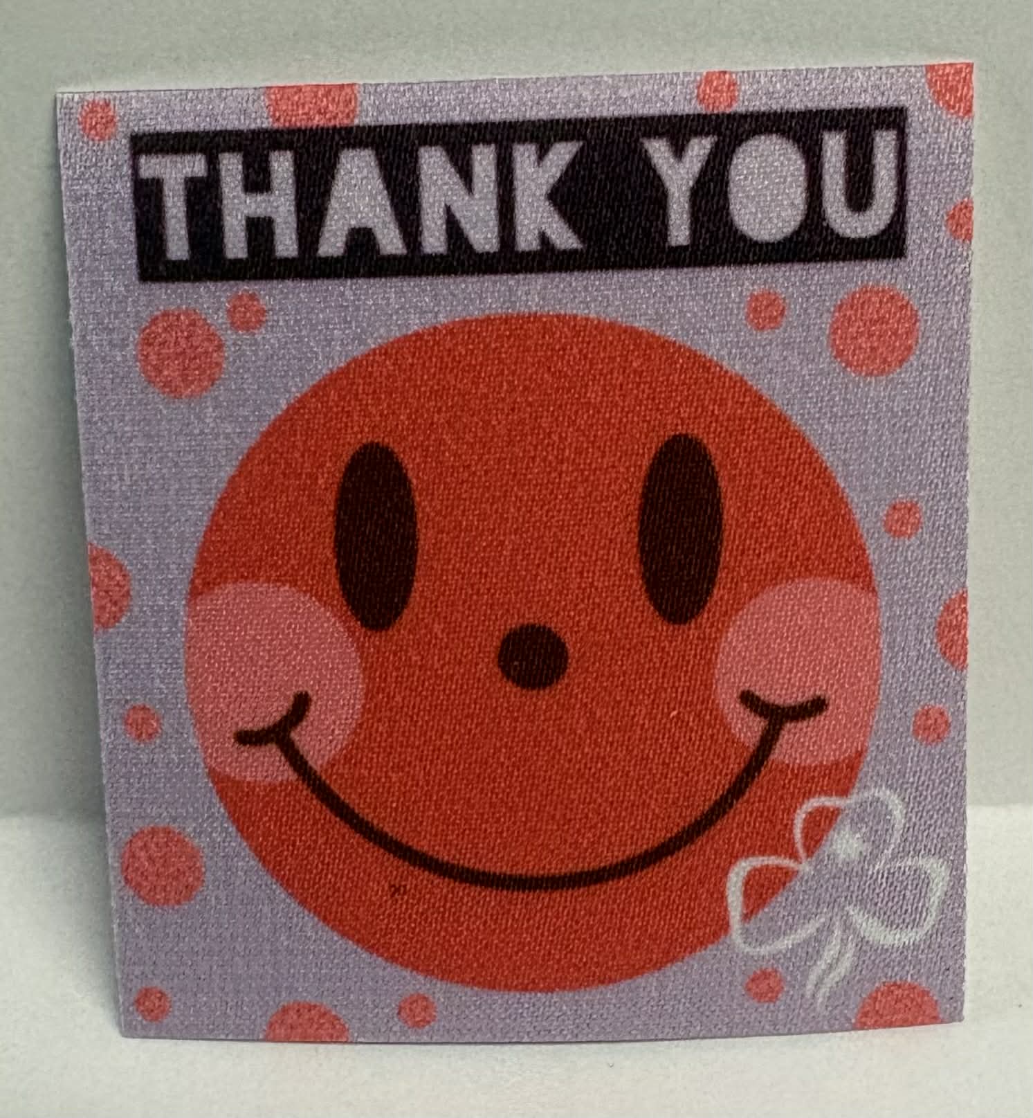 Square unbound badge with a smiley face and 'THANK YOU' text on a light gray background