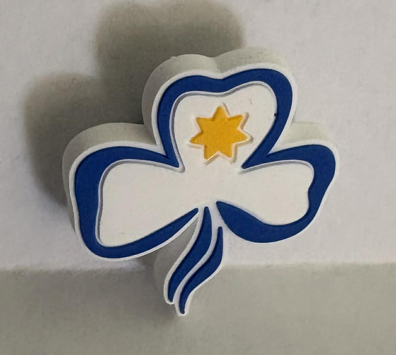 a trefoil shaped charm for croc shoes