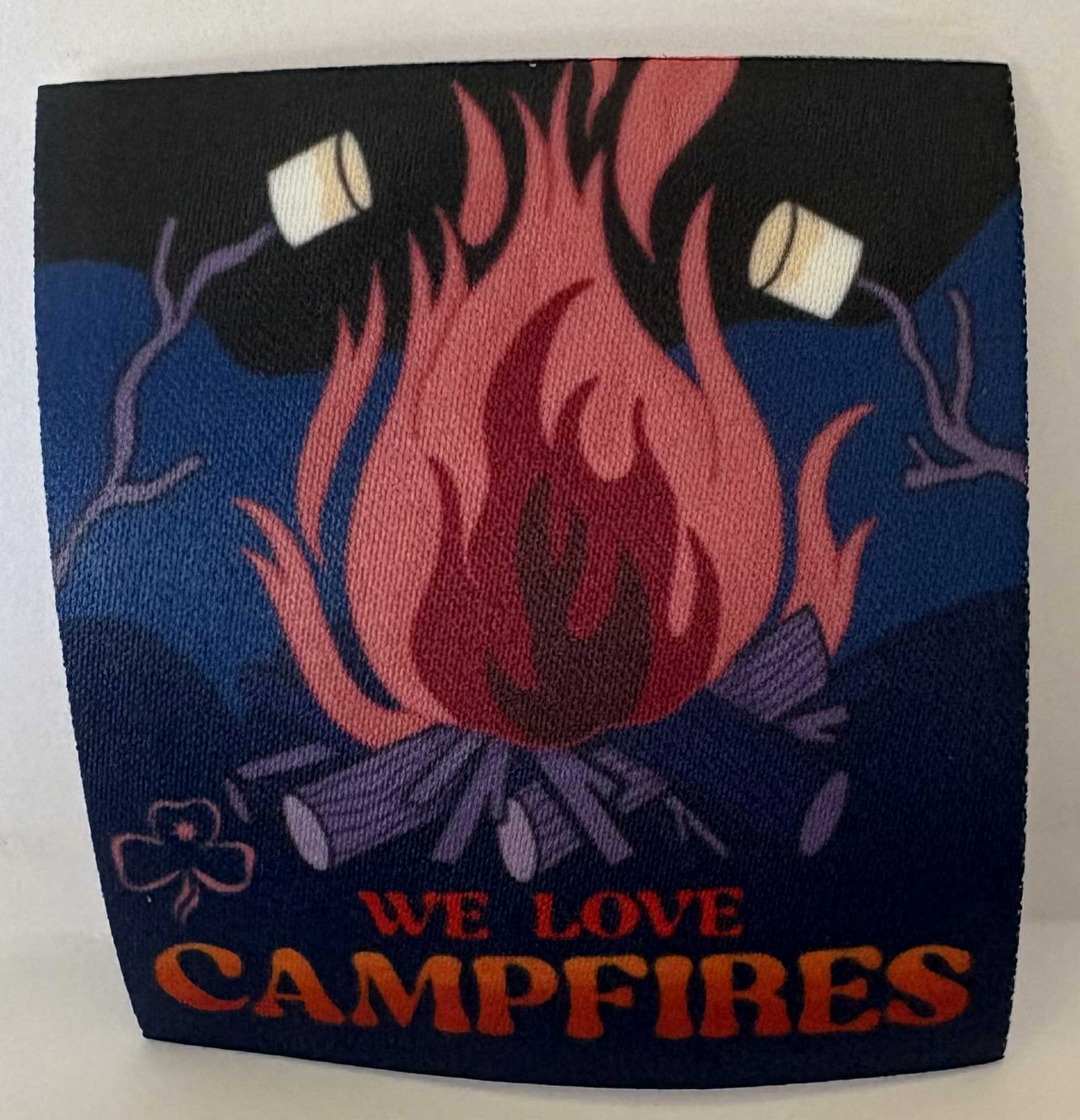 a square unbound badge with a campfire design and 'We Love Campfires' text on a dark blue background
